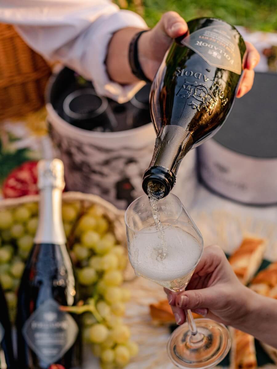 person pooring prosecco